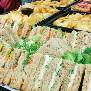 A selection of sandwiches, crisps, savoury snacks and dips. Corporate catering for meetings, lunches and parties.  Close up image of food.